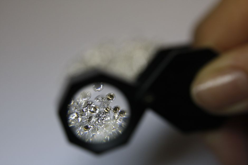 Appraiser examining a gemstone with a loupe