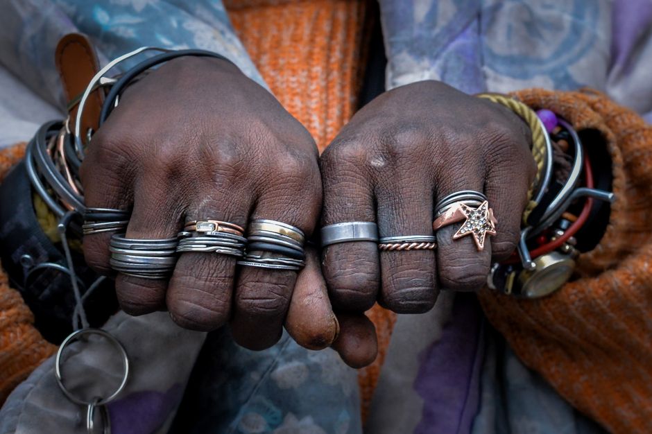 Copper-toned rings worn on a hand